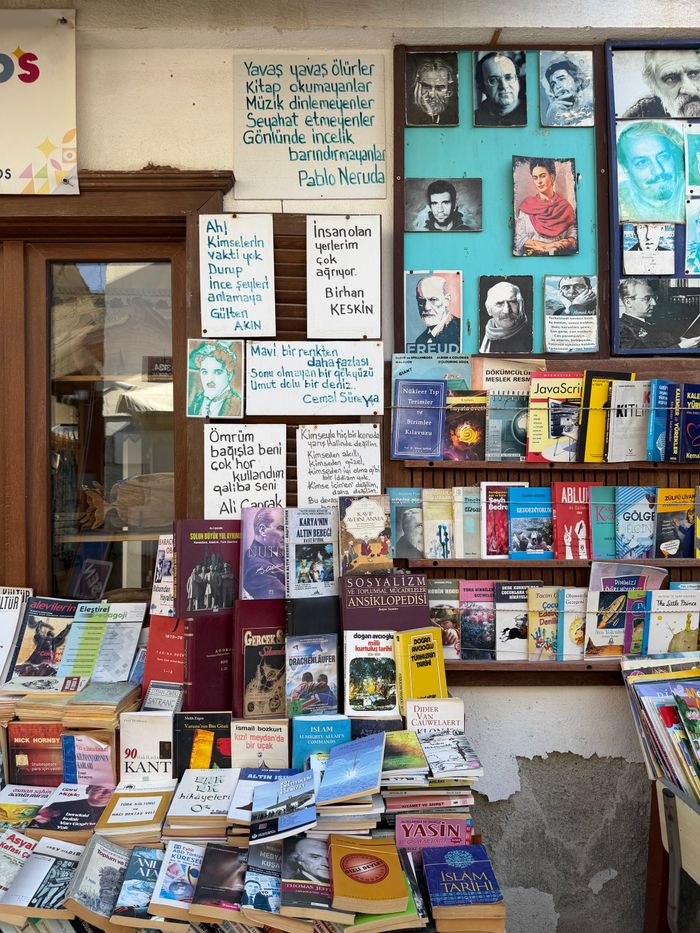 our-mission Charming outdoor display of books and quotes at a bookstore in İzmir, Türkiye, featuring portraits of famous authors.